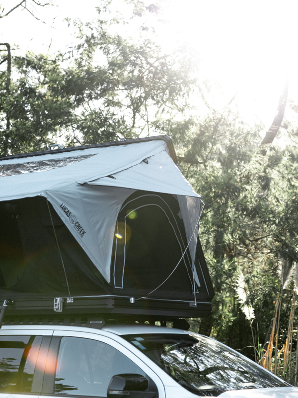 Side view of the D-Luxe Aluminium Hard Shell Roof top tent showing the side window awnings that are fully removable or rolled up during good weather for easy pack down 