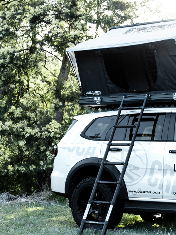 Lucas Creek D-luxe tent open on the vehicle showing the top quality easy step Lucas Creek 2.3 m telescopic ladder